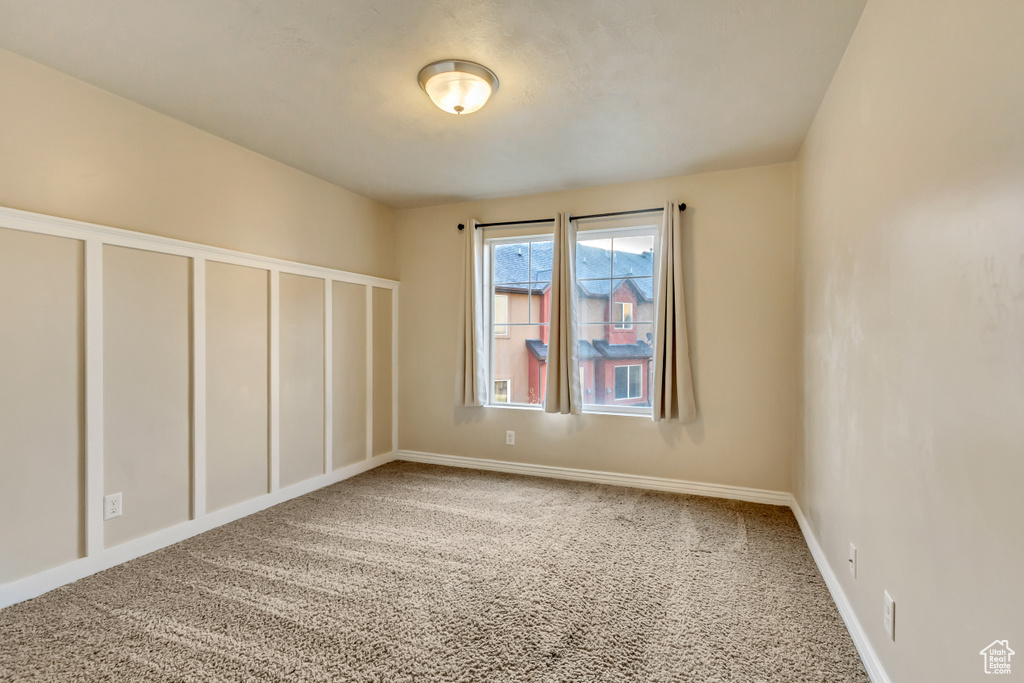 Unfurnished room with carpet