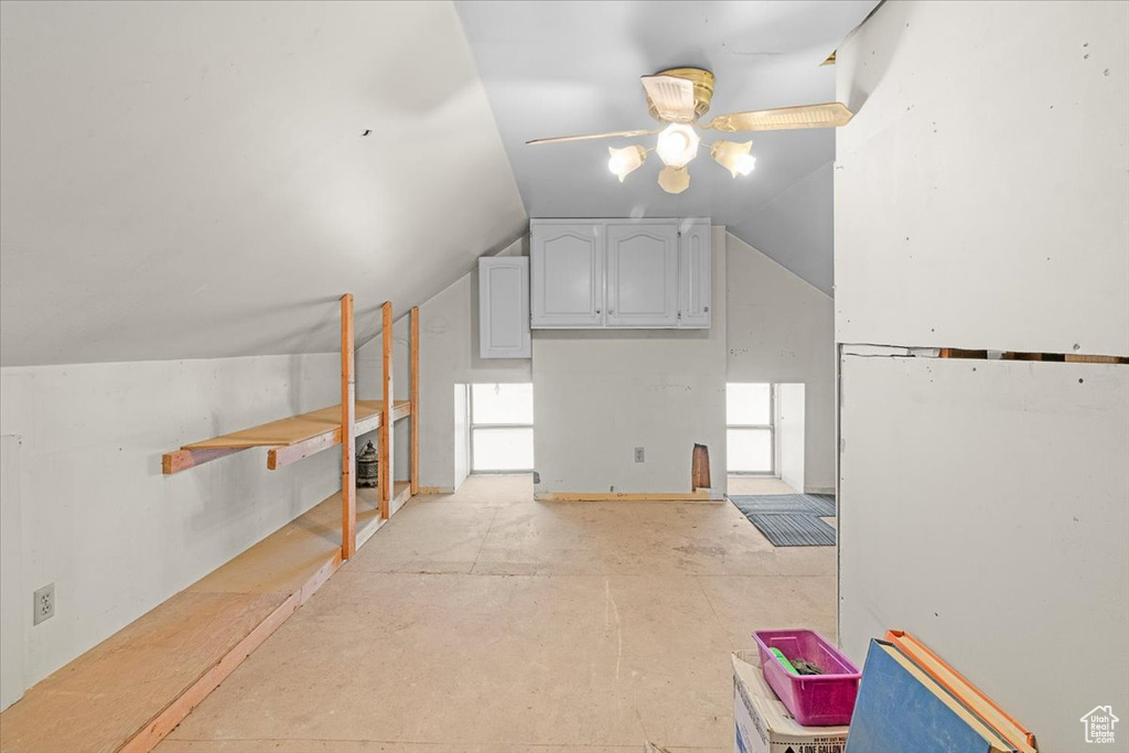 Additional living space with ceiling fan and vaulted ceiling