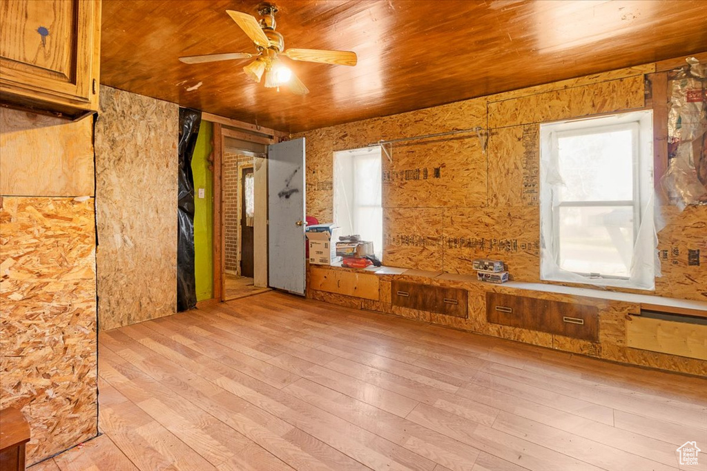 Unfurnished room with light wood-type flooring, wood ceiling, and ceiling fan