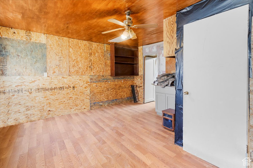 Empty room with wooden ceiling, ceiling fan, and light hardwood / wood-style flooring