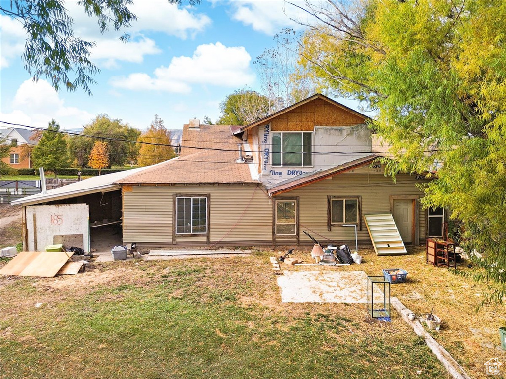 Back of property with a yard and a patio area