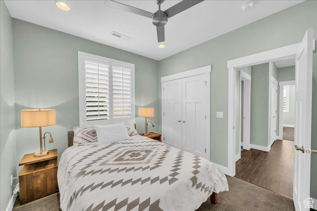 Bedroom with a closet, hardwood / wood-style flooring, and ceiling fan