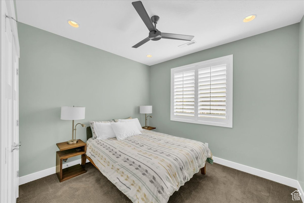 Carpeted bedroom with ceiling fan