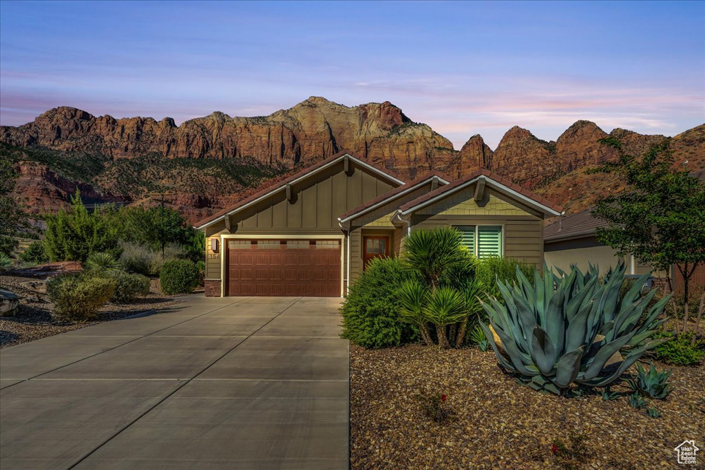 View of front facade with a mountain view and a garage