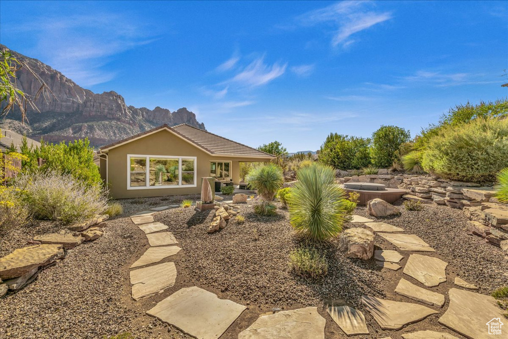 Rear view of house with a patio area and a mountain view