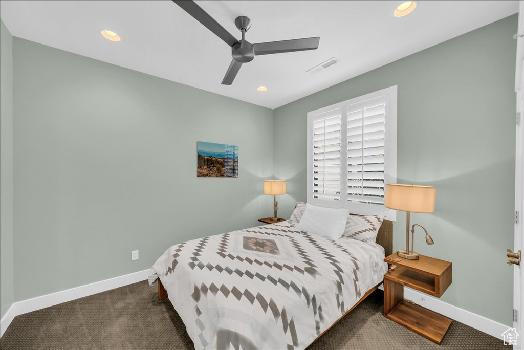 Carpeted bedroom with ceiling fan