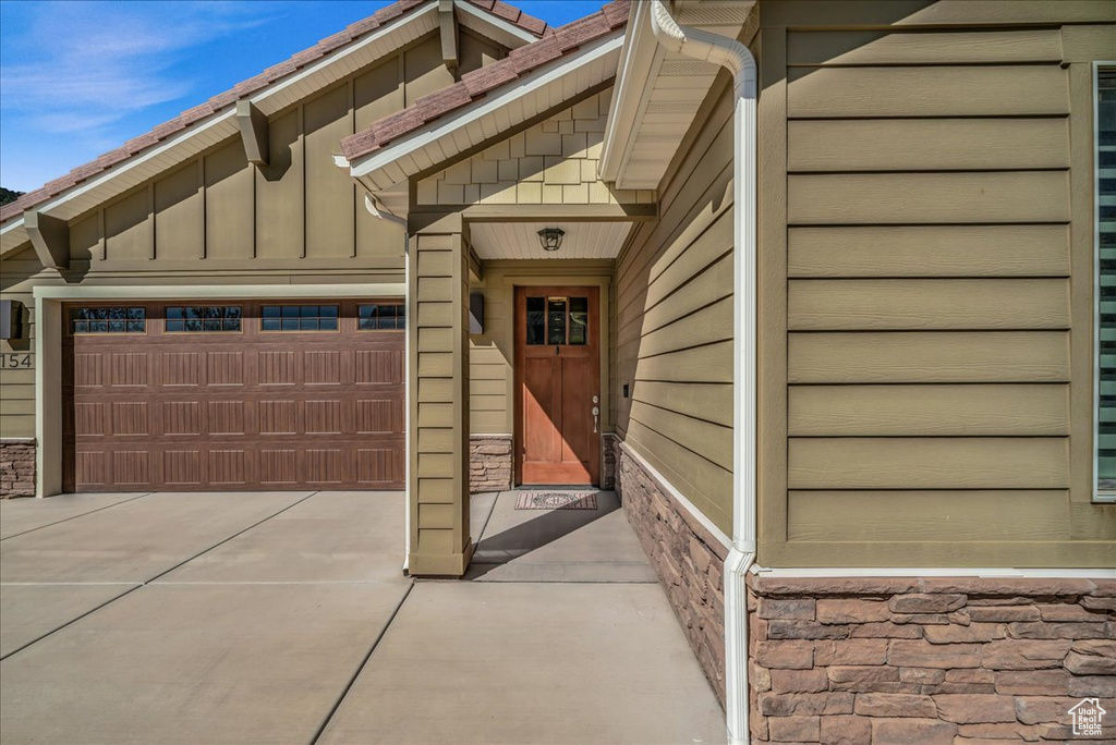 Doorway to property featuring a garage