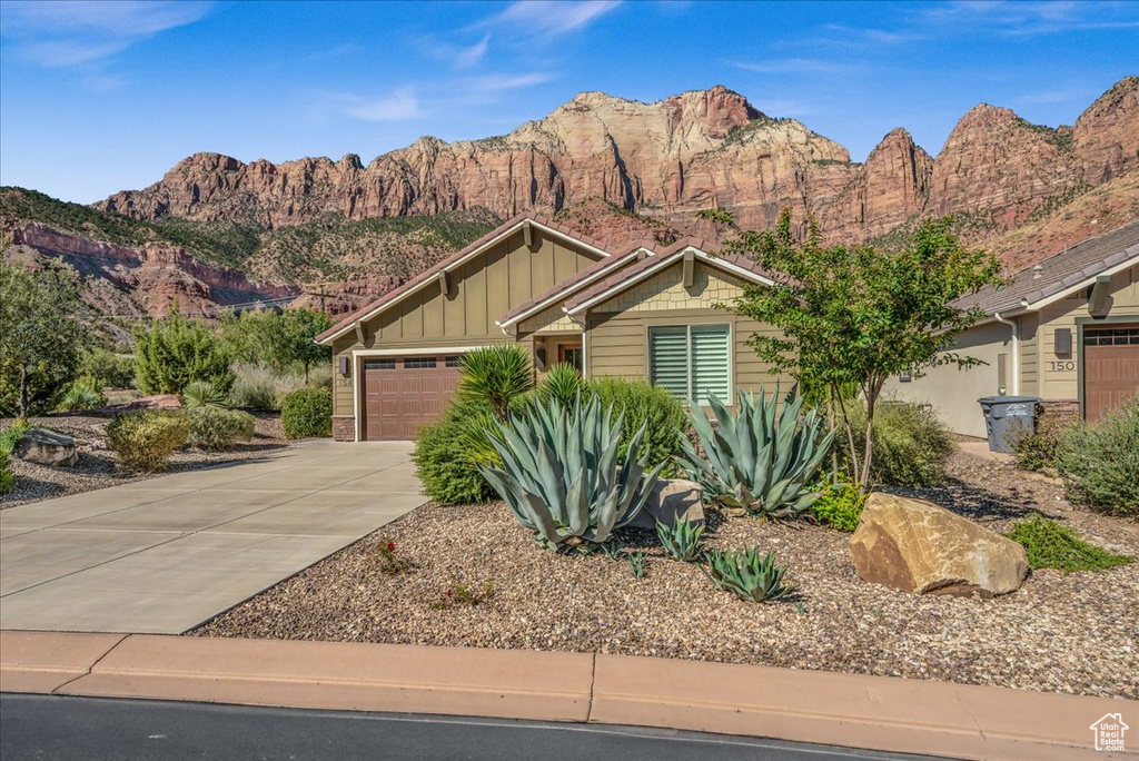 View of front of house featuring a garage and a mountain view