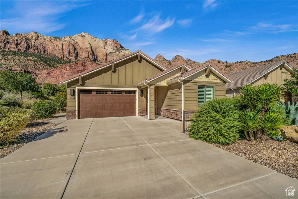 View of front facade featuring a garage and a mountain view