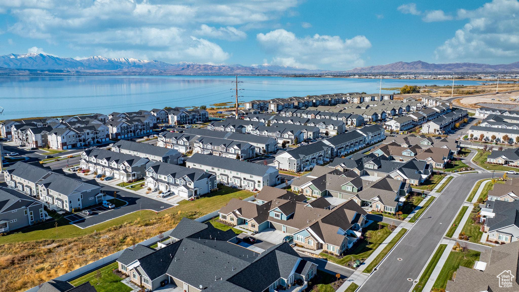 Birds eye view of property with a water and mountain view