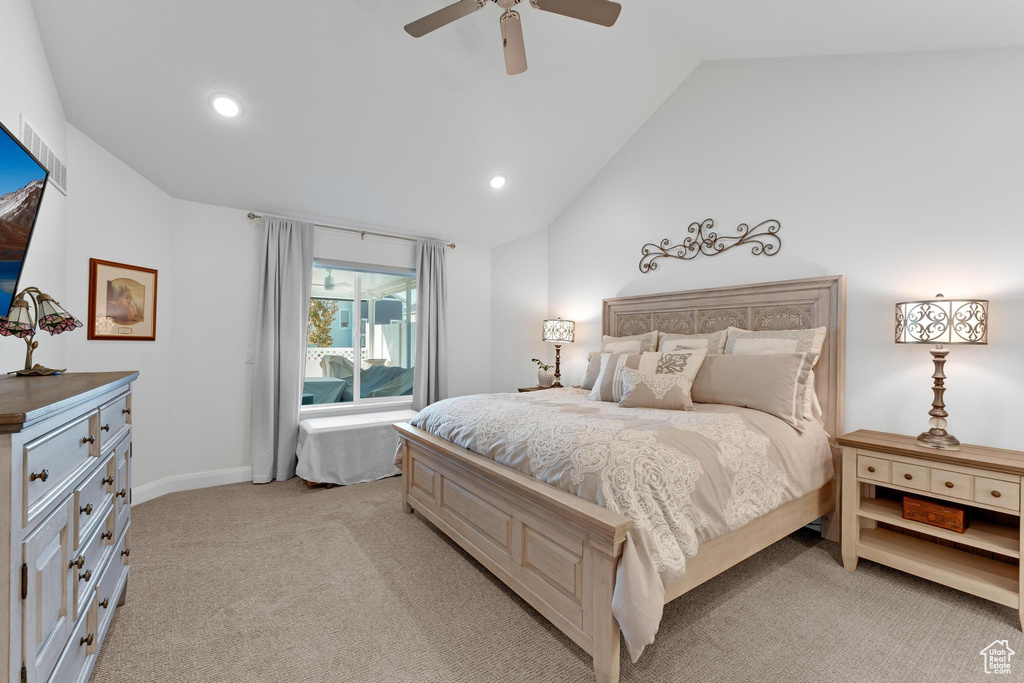 Carpeted bedroom with lofted ceiling and ceiling fan