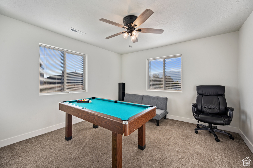 Game room with pool table, a textured ceiling, light carpet, and ceiling fan