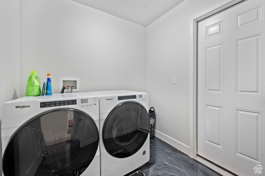 Laundry room with washing machine and clothes dryer