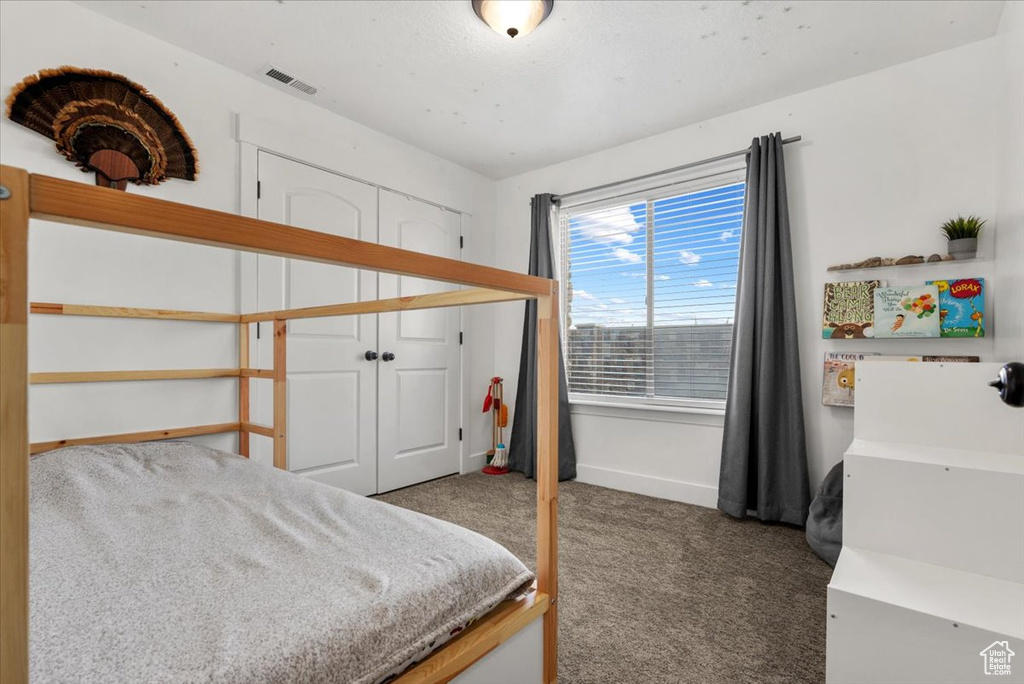 Bedroom featuring a closet and carpet floors