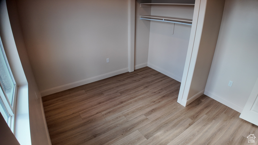 Unfurnished bedroom with a closet and light hardwood / wood-style flooring