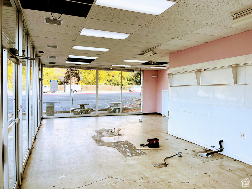 Misc room with a drop ceiling and concrete floors