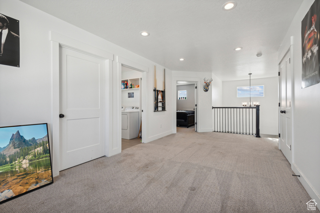 Interior space featuring a chandelier and washer / dryer