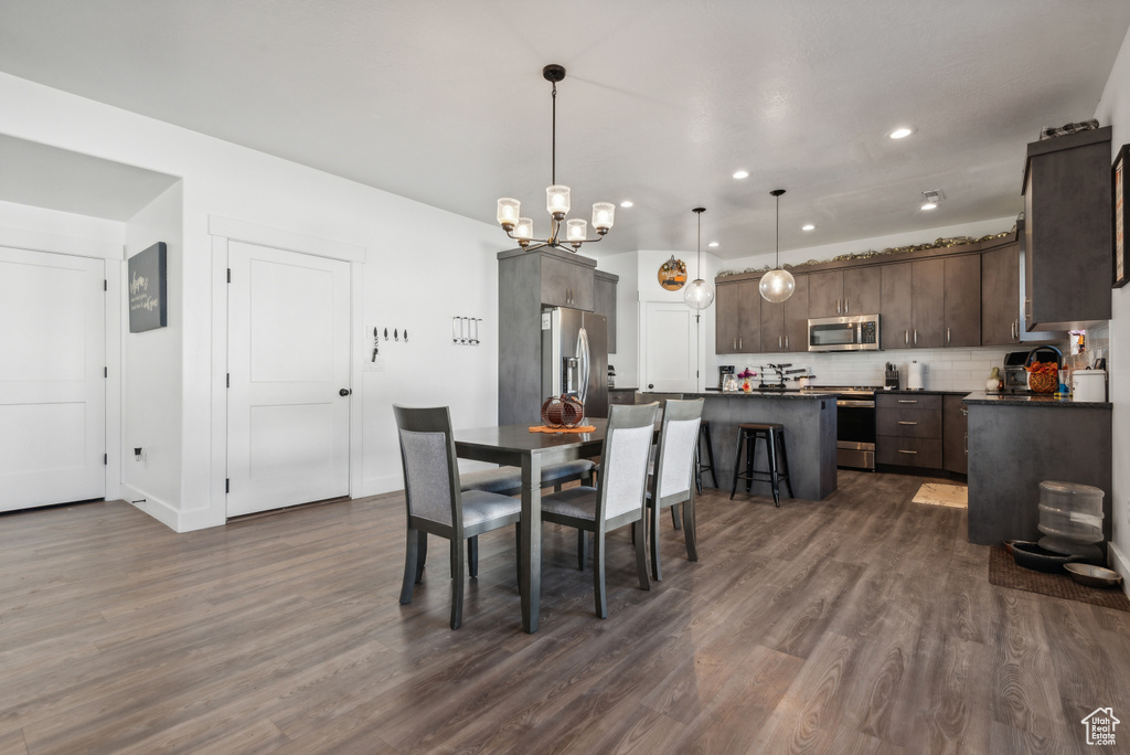 Dining space with dark wood-type flooring