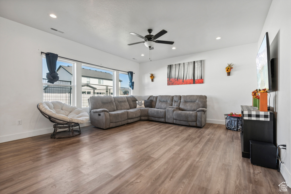 Living room featuring hardwood / wood-style floors and ceiling fan