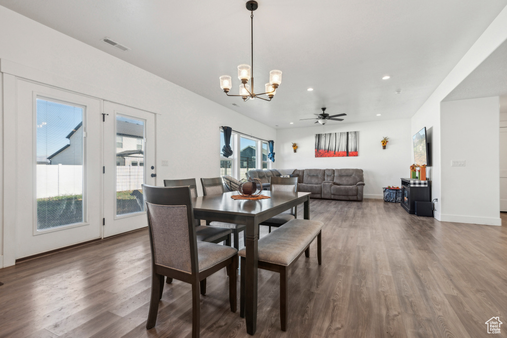 Dining area with dark hardwood / wood-style flooring and ceiling fan