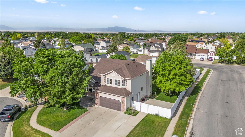 Aerial perspective of suburban area with a mountain backdrop