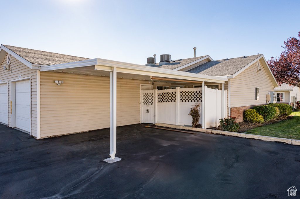 View of home's exterior with a garage and a carport