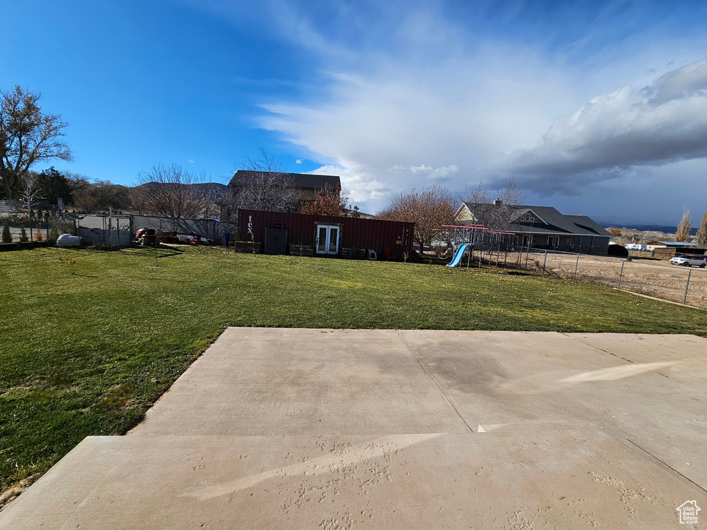 View of yard featuring a playground and a patio area