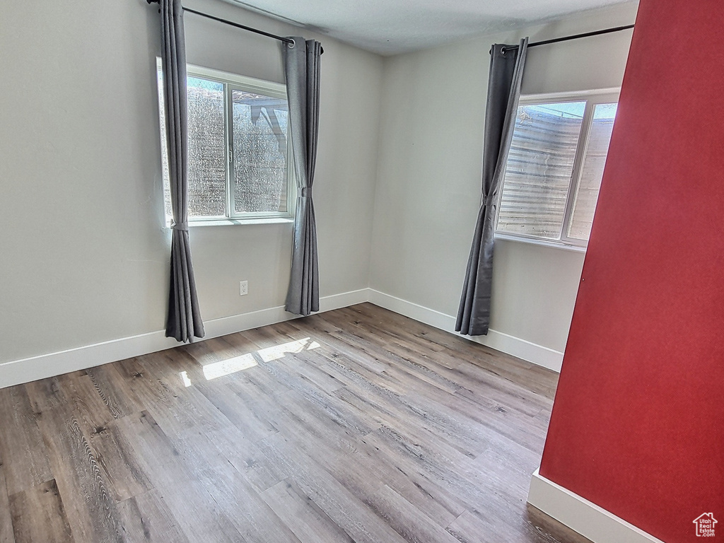 Spare room with light hardwood / wood-style flooring and plenty of natural light