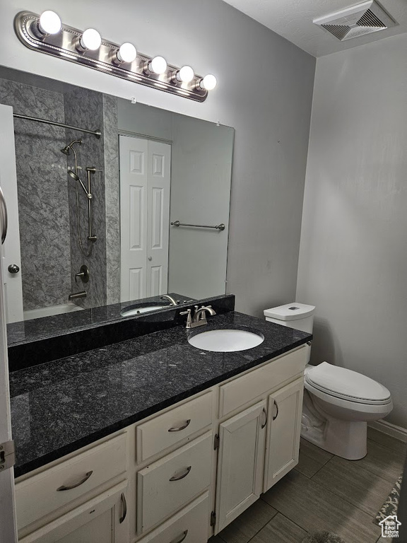 Full bathroom featuring vanity, toilet, and tiled shower / bath