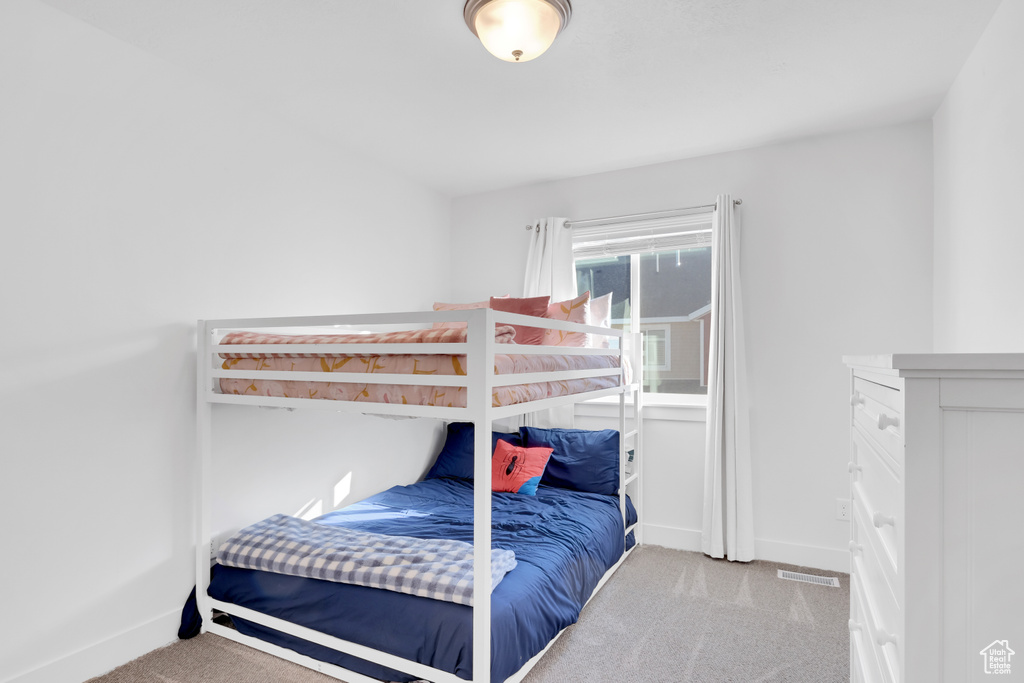 Bedroom with light carpet