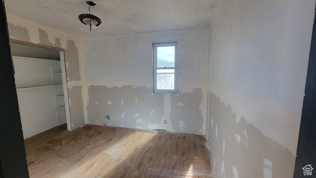 Unfurnished bedroom with a closet and wood-type flooring