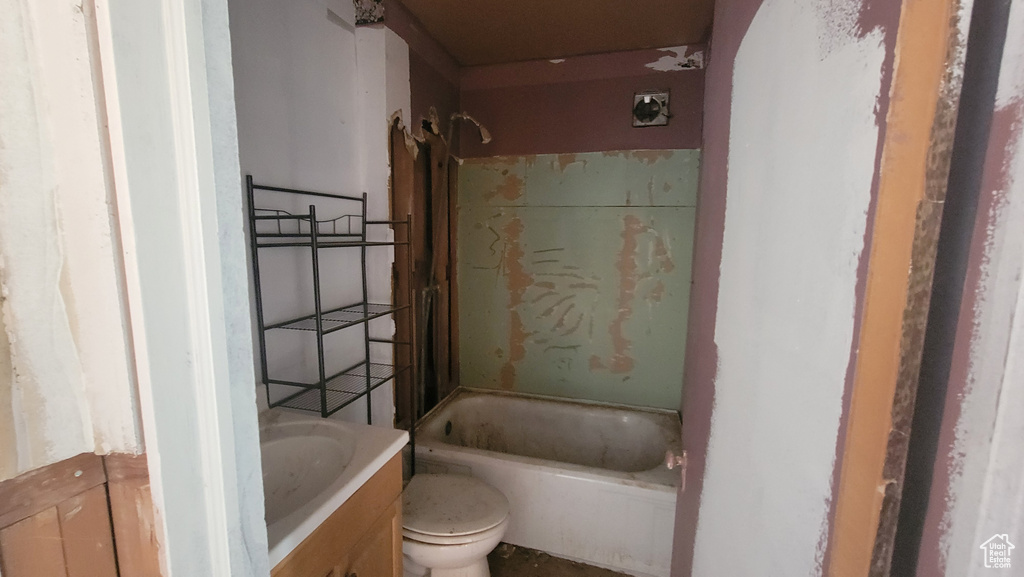 Full bathroom with toilet, washtub / shower combination, and vanity