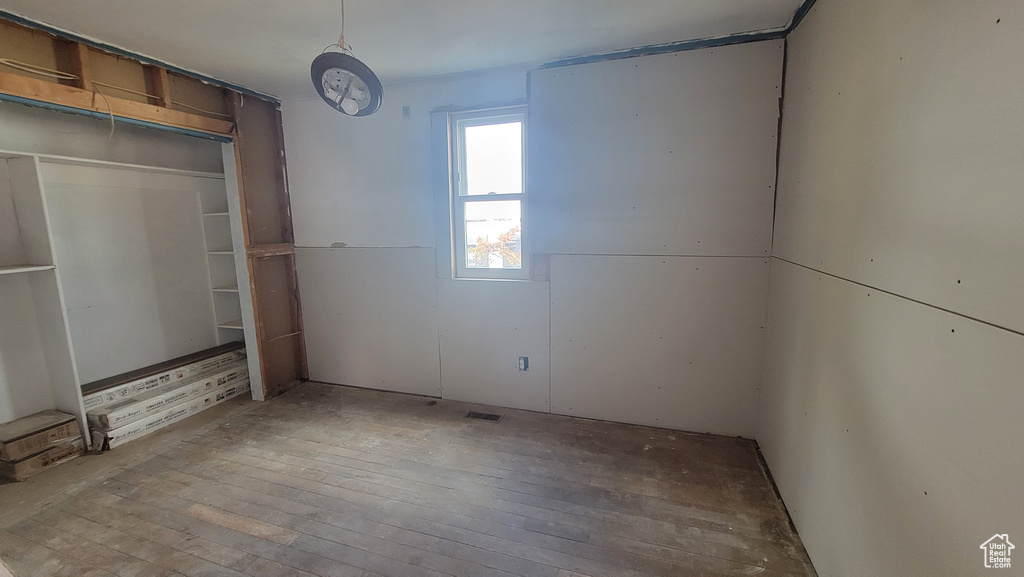 Unfurnished bedroom with hardwood / wood-style floors