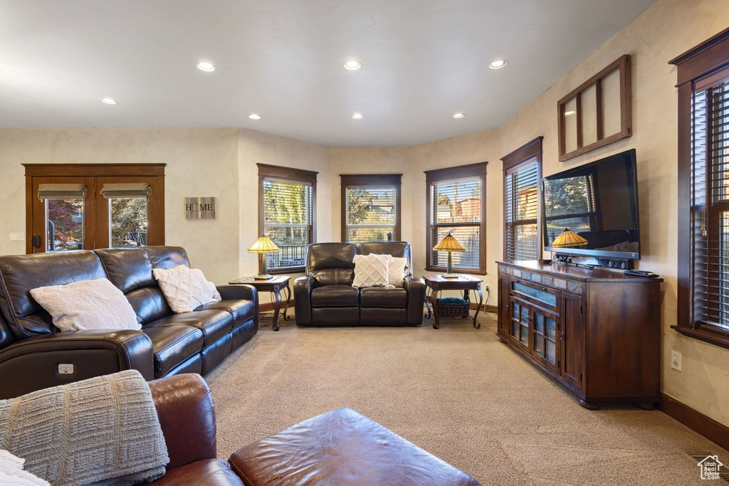 Living room with light colored carpet and plenty of natural light