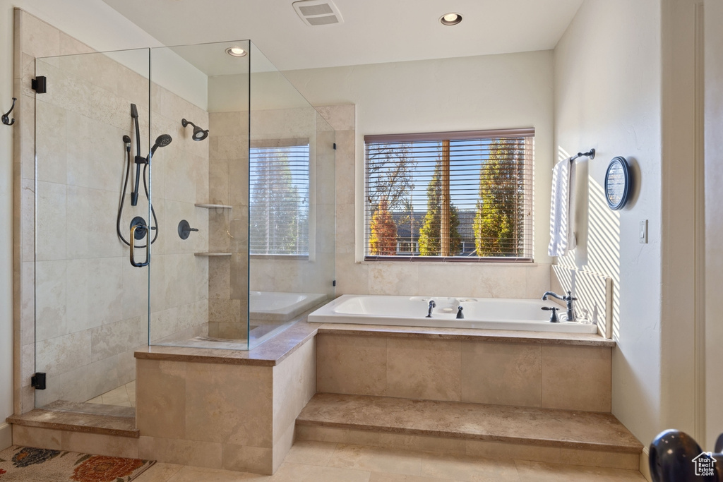 Bathroom with plus walk in shower and tile patterned flooring