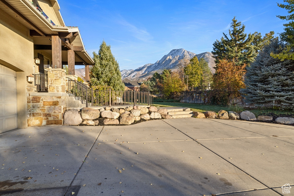 View of patio featuring a mountain view and a garage