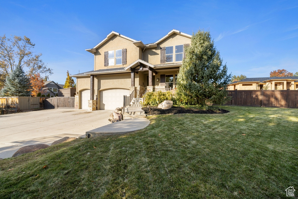 View of front facade with a garage and a front yard