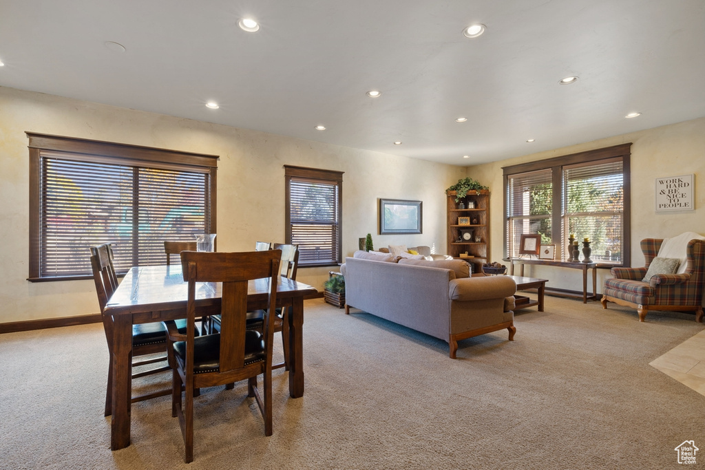 Dining space featuring light carpet