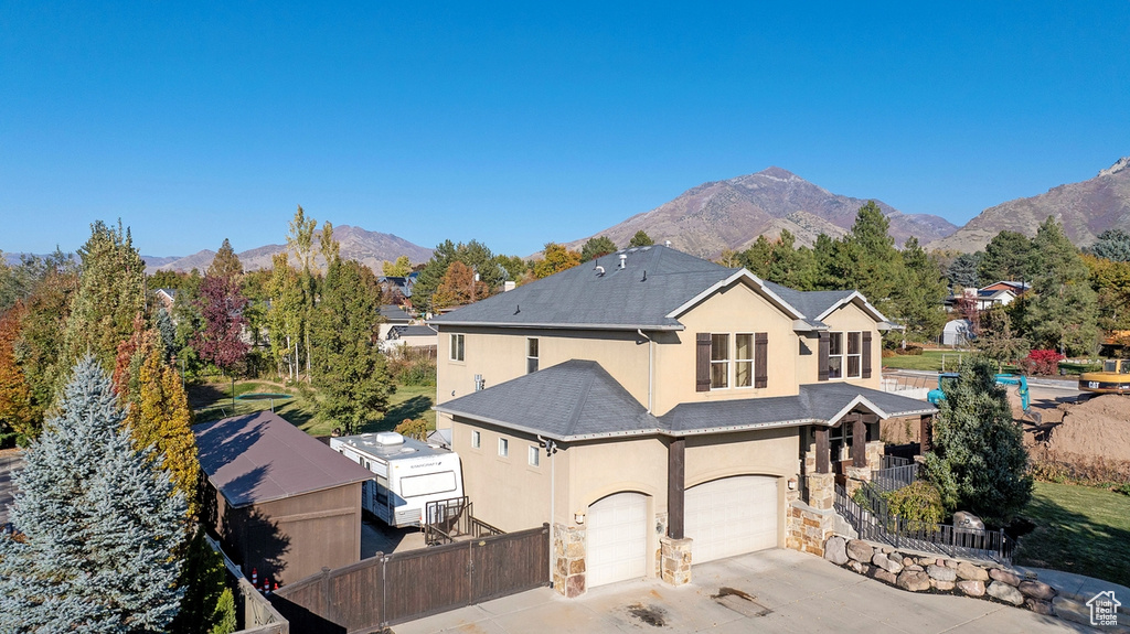 View of front of house featuring a mountain view and a garage