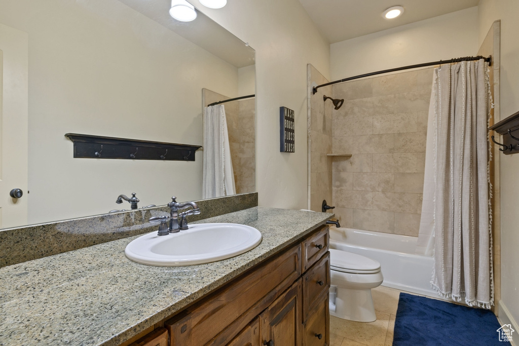 Full bathroom with toilet, vanity, tile patterned flooring, and shower / bathtub combination with curtain