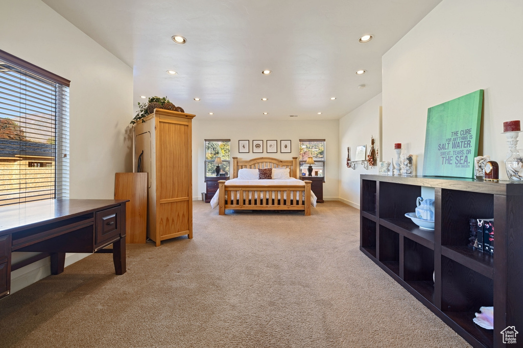 Bedroom featuring light carpet