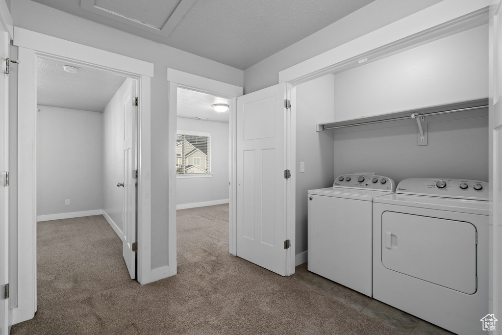 Laundry room with carpet flooring and separate washer and dryer