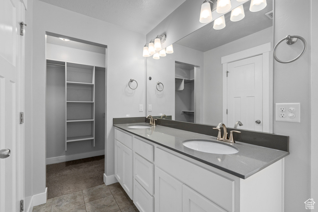 Bathroom featuring vanity and tile patterned flooring