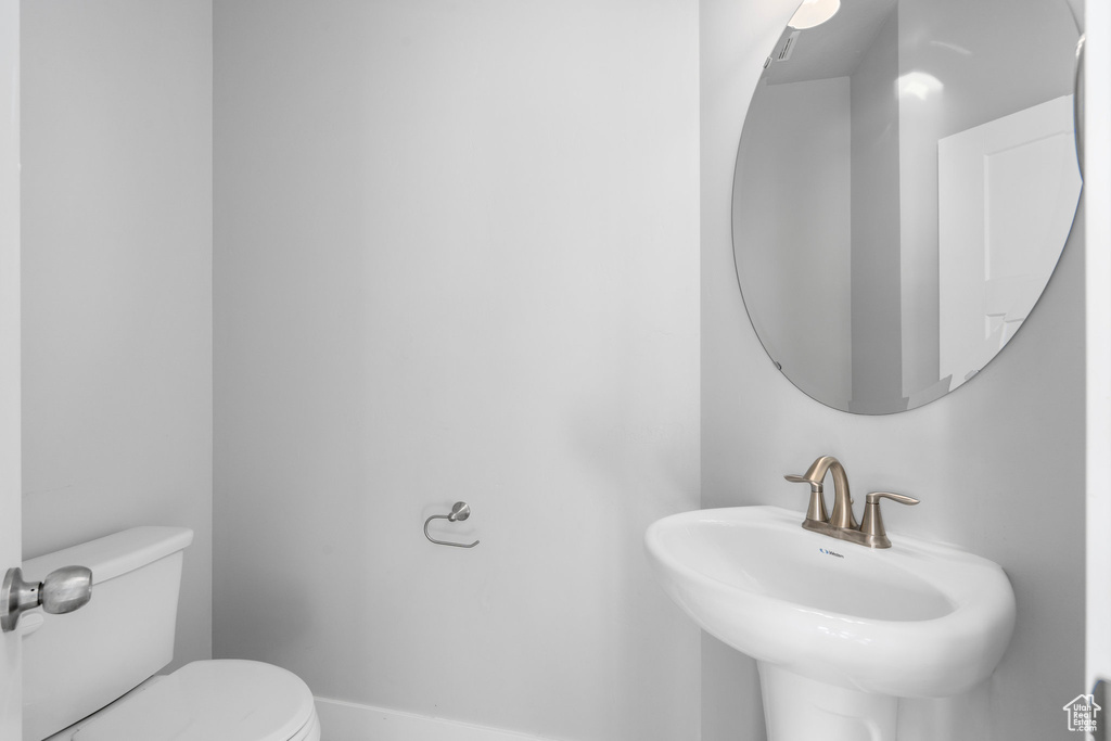 Bathroom featuring sink and toilet