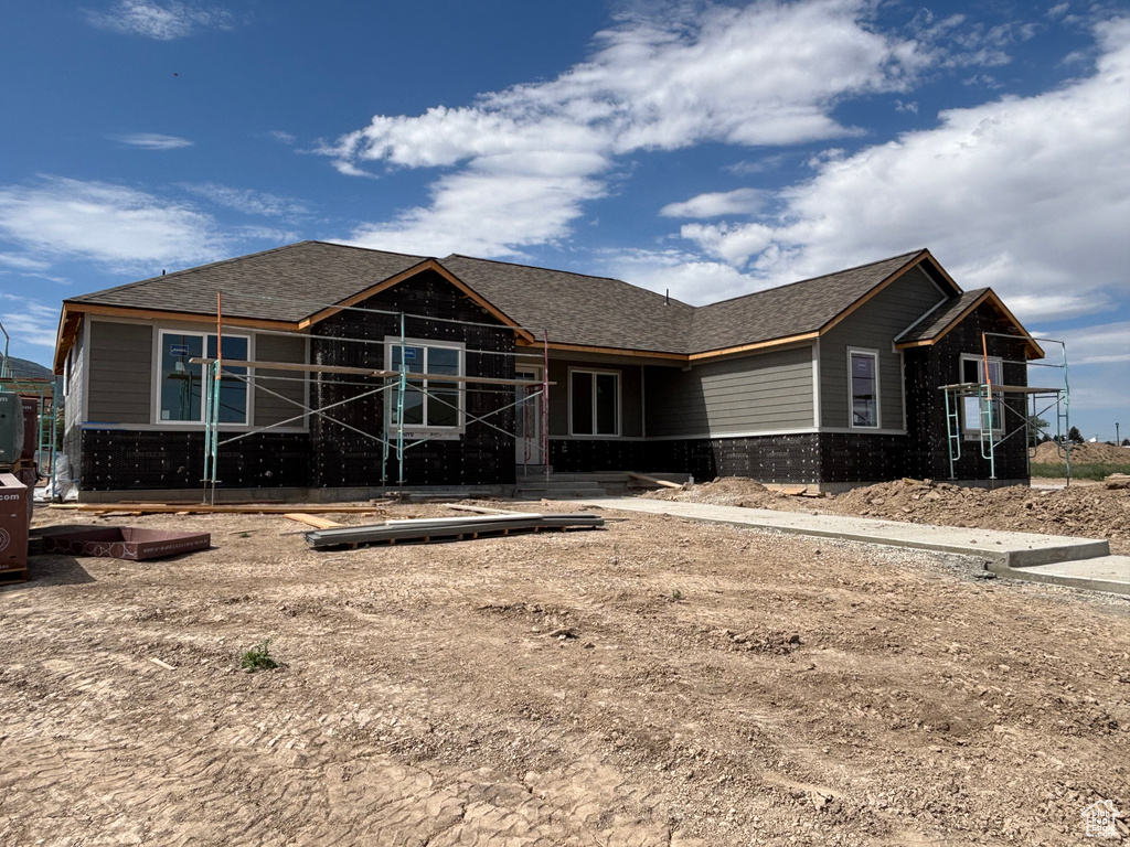 View of front of house with brick siding and a shingled roof