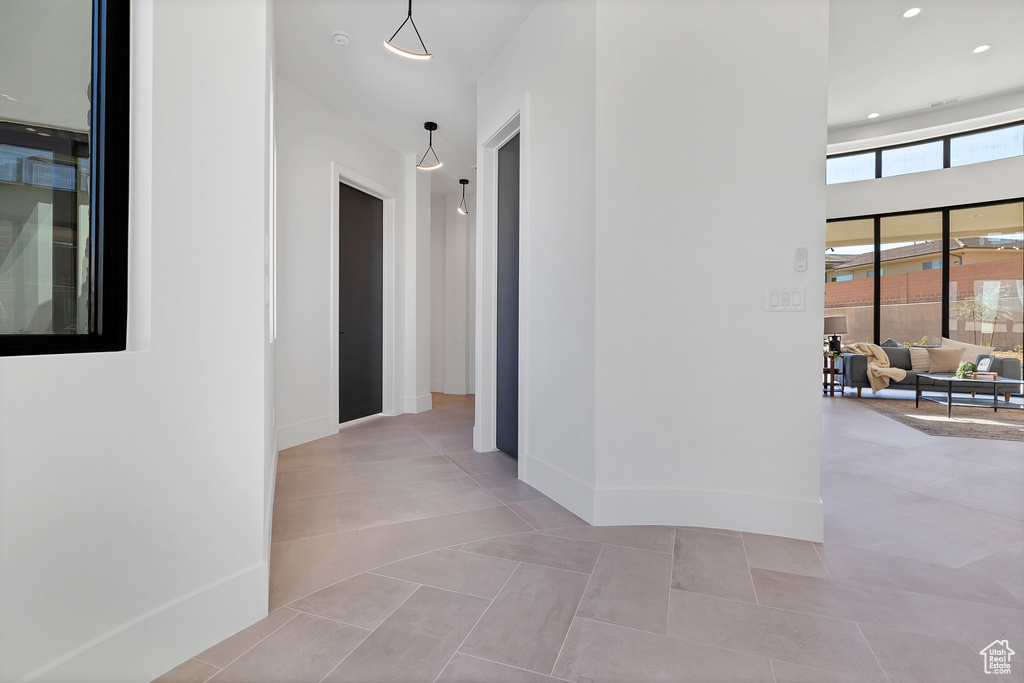 Corridor featuring light tile patterned floors