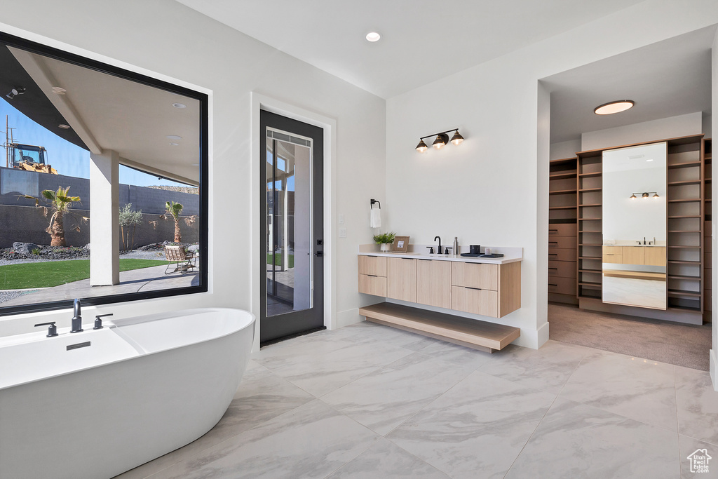 Bathroom with a tub to relax in and vanity