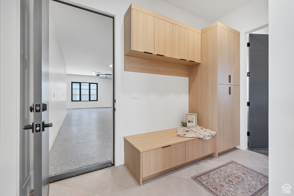 Mudroom with light tile patterned flooring