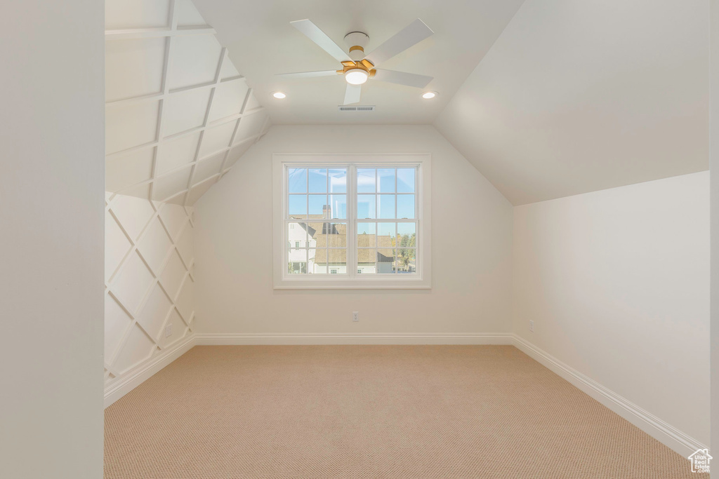 Bonus room featuring vaulted ceiling, carpet flooring, and ceiling fan