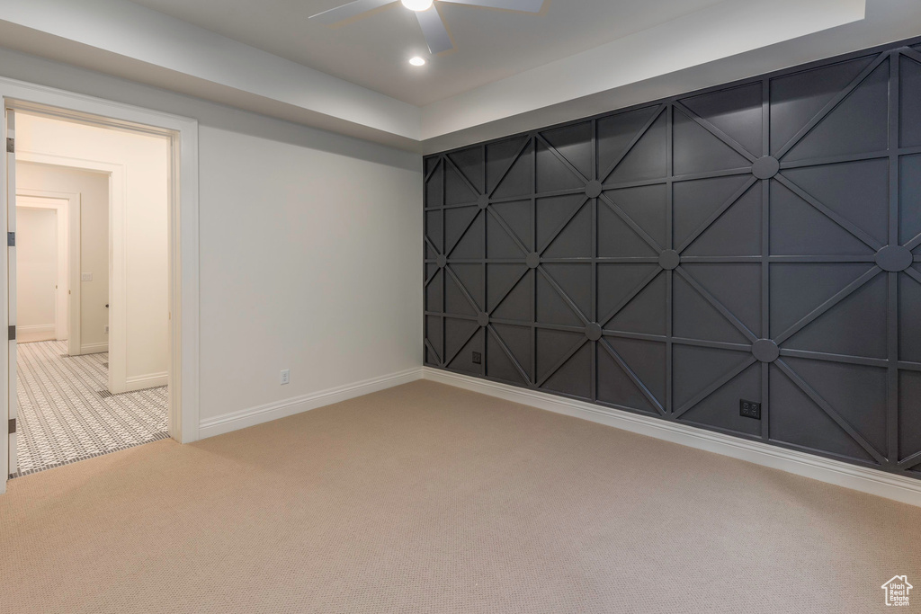 Unfurnished room with light colored carpet and ceiling fan